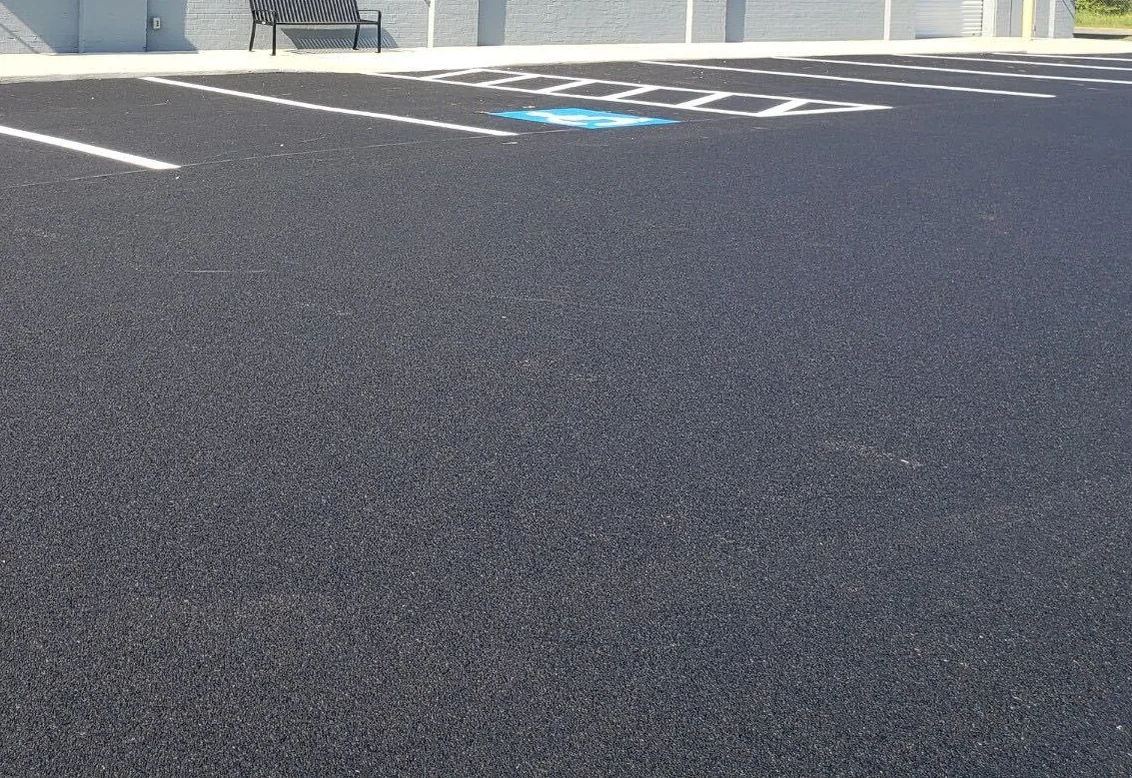 Newly painted accessible parking space and stalls on a freshly sealed commercial lot